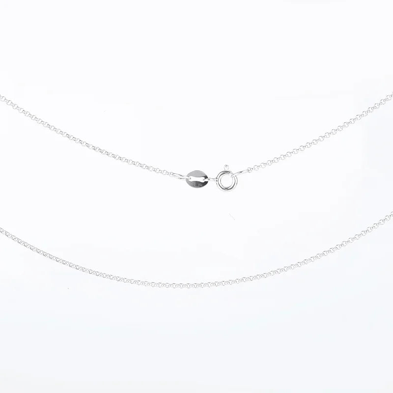 Silver necklace with a small round pendant on a white background