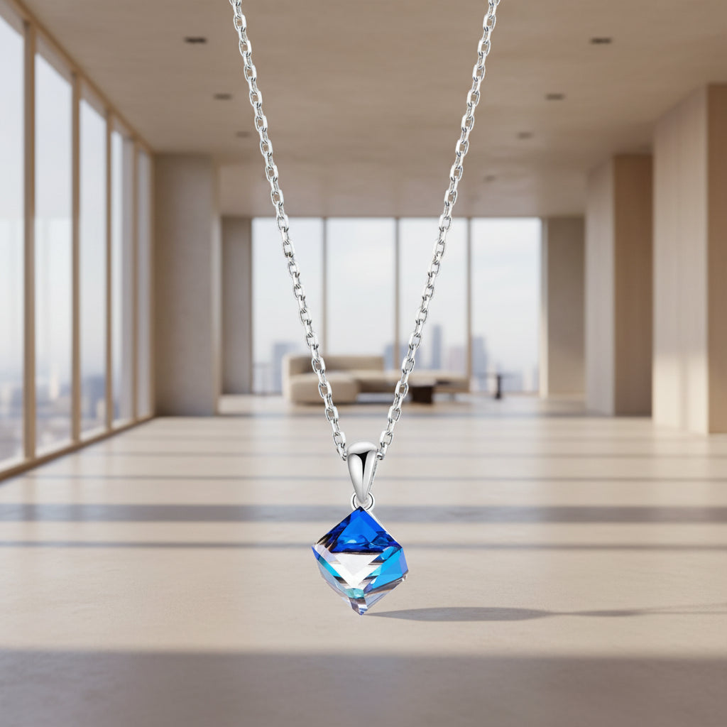 Blue crystal pendant necklace on a white background