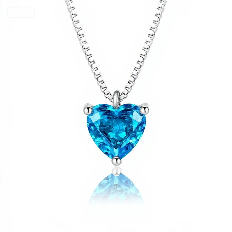 Heart-shaped blue gemstone necklace on a white background