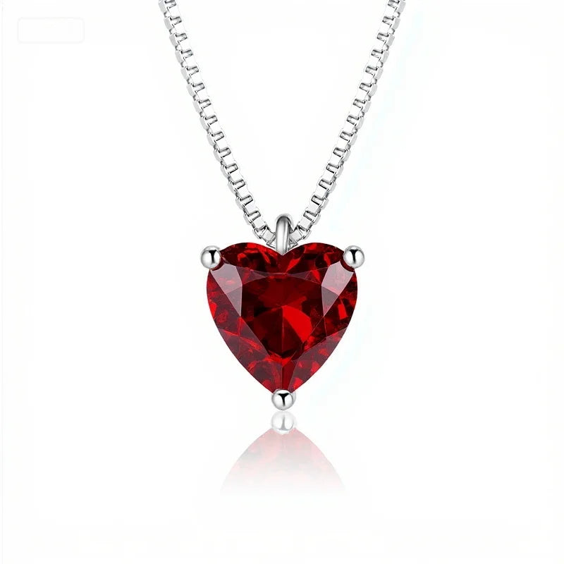 Red heart-shaped gemstone necklace on a white background