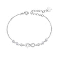 Silver bracelet with infinity symbol and heart charm on a white background