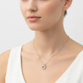 Silver necklace with interlocking rings and small diamonds on a white background