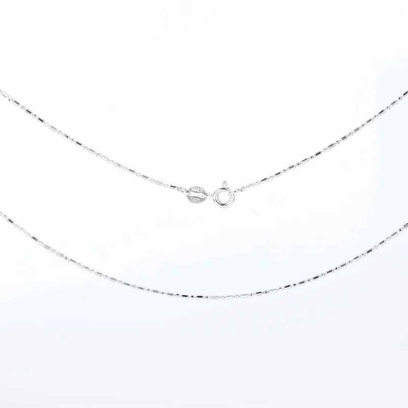 Silver necklace with a small pendant on a white background