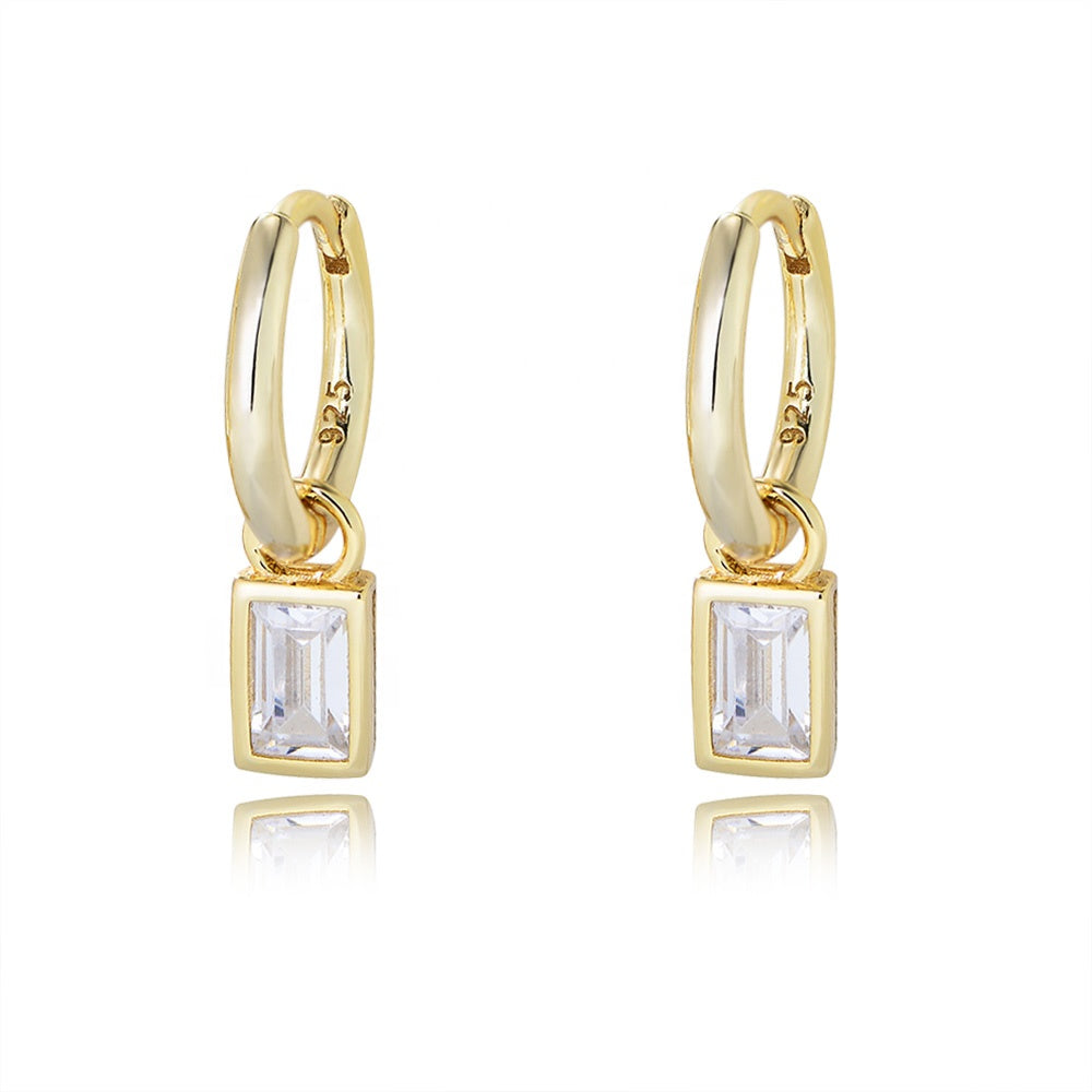 Gold hoop earrings with square gemstones on a white background