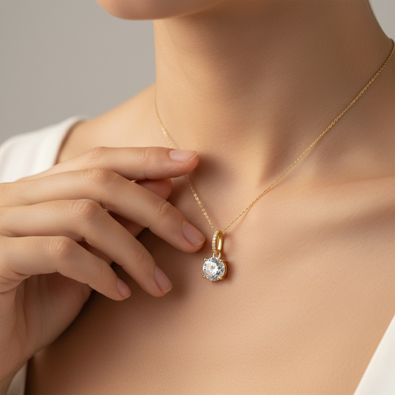 Gold vermeil round brilliant solitaire pendant necklace worn at the collarbone