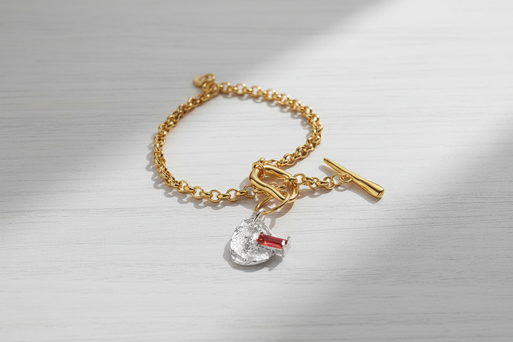 Toggle Bracelet with Charm on White Wooden Table