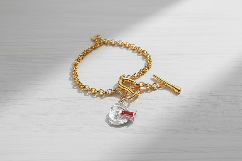 Toggle Bracelet with Charm on White Wooden Table